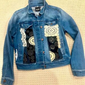 Turn heads with this one of a kind upcycled denim jacket! Size medium.